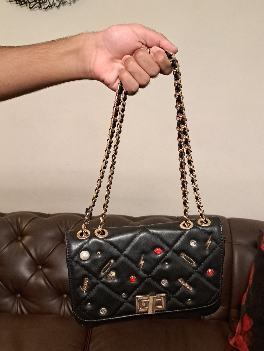 Aldo Black Quilted Crossbody Bag with Gold Hardware and Red Accent Charms